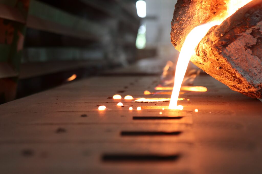 Molten metal being poured into molds.