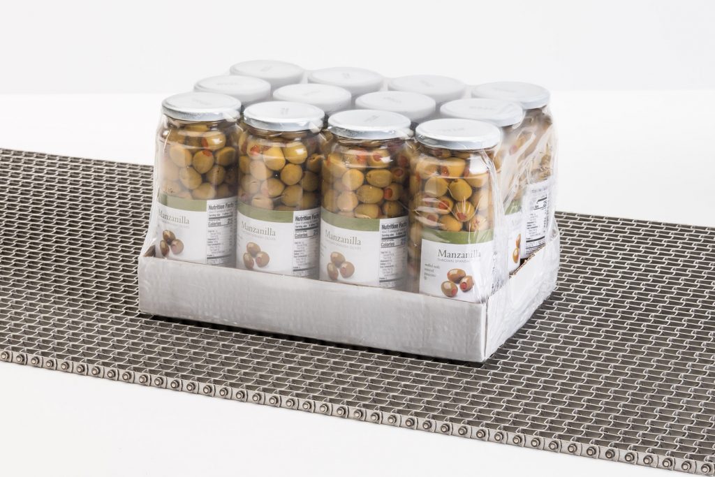 A flat wire conveyor belt transporting a case of jars of olives.