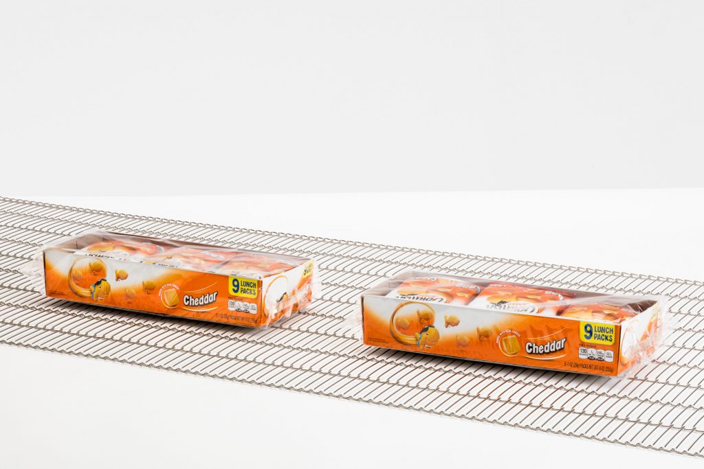 A flat flex conveyor belt transporting goldfish crackers.