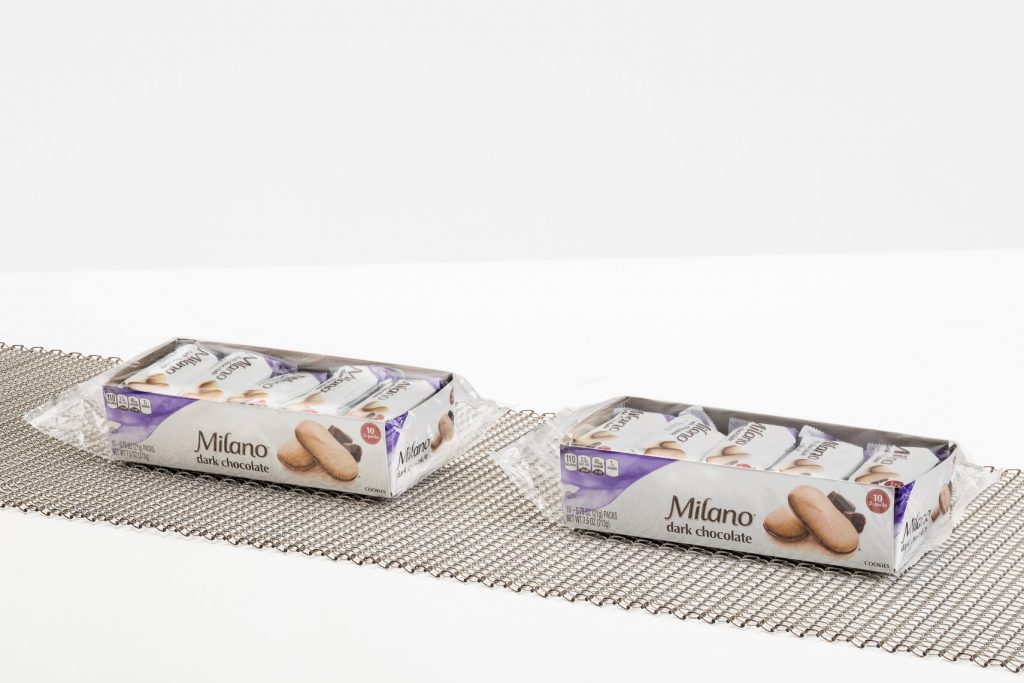 A balanced weave conveyor belt transporting Milano cookies.
